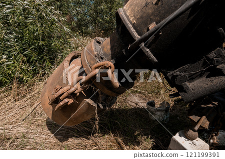 Rusty Industrial Machinery Surrounded by Overgrown Vegetation 121199391