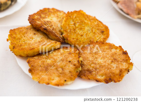 Potato pancakes with sour cream on white plate 121200238