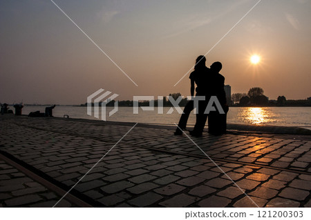 Experience the enchanting Romantic Silhouette as the sun sets by the Waters Edge Experience the enchanting Romantic Silhouette as the sun sets by the Waters Edge 121200303