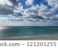 A tranquil seaside scene with blue sky and clouds 121201255