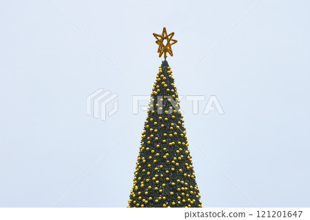 Christmas tree with a star on top decorated with balls and garlands Christmas tree with a star on top decorated with balls and garlands 121201647
