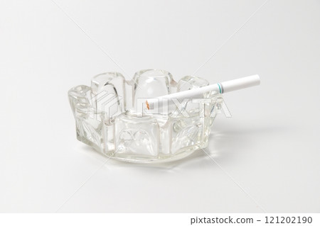 Unused cigarettes in a glass ashtray 121202190