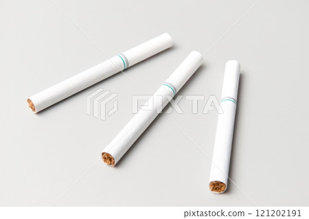 Three unused cigarettes lined up 121202191