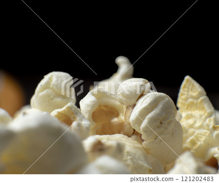 close up of freshly popped popcorn. Popcorn ready for movie night snacking 121202483