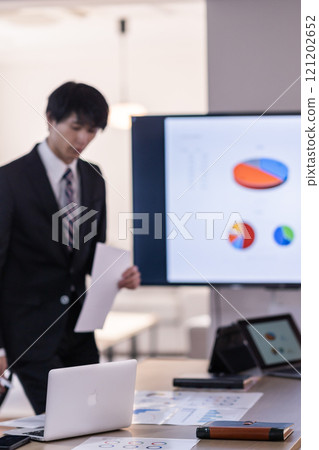 Copy paper and a computer arranged haphazardly on a desk Copy paper and a computer arranged haphazardly on a desk 121202652