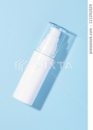 A white cosmetic tube on a pastel blue background 121202829