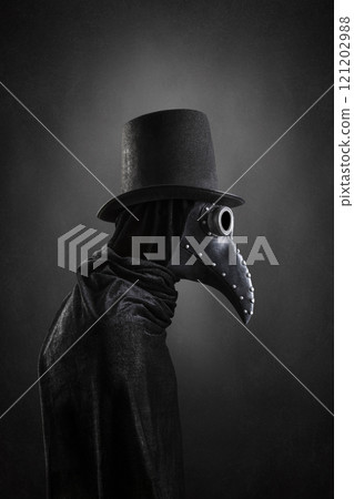 Plague doctor with black vintage top hat at night over dark misty background Plague doctor with black vintage top hat at night over dark misty background 121202988