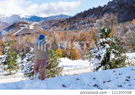 happy young woman from the back in a warm jacket and hat running and enjoying the snow in winter against the backdrop of a picturesque forest in the mountains copy space happy young woman from the back in a warm jacket and hat running and enjoying the snow in winter against the backdrop of a picturesque forest in the mountains copy space 121203506