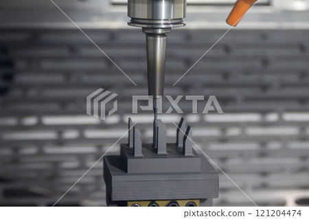 The CNC milling machine cutting the graphite electrode parts. The CNC milling machine cutting the graphite electrode parts. 121204474