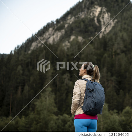 Hiker admiring the mountain view 121204695
