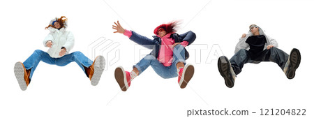 Three stylish young people in creative low-angle poses, in modern street fashion outfits and bold footwear against white background. Bottom view 121204822