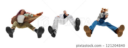 Three stylish people in casual and trendy clothing posing in dynamic pose against white background. Bottom view. Modern lifestyle. 121204840