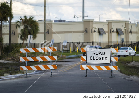 Yellow protective barrier at street construction site. Warning road sign about utility work 121204928