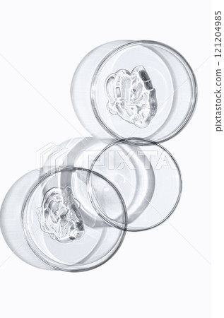 A sample of skin serum or moisturizing gel in a Petri dish. A cosmetic product. A sample of skin serum or moisturizing gel in a Petri dish. A cosmetic product. 121204985