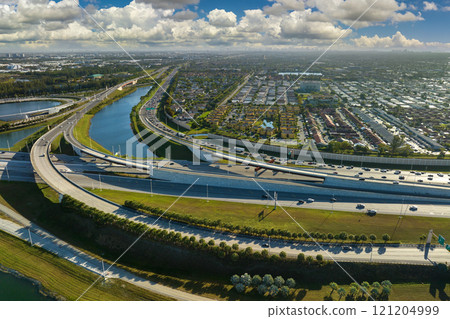 View from above of USA transportation infrastructure. Aerial view of american freeway intersection with fast driving cars and trucks in Miami, Florida View from above of USA transportation infrastructure. Aerial view of american freeway intersection with fast driving cars and trucks in Miami, Florida 121204999