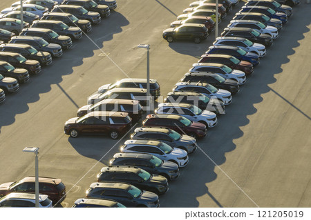 View from above of dealers outdoor parking lot with many brand new cars in stock for sale. Concept of development of american automotive industry View from above of dealers outdoor parking lot with many brand new cars in stock for sale. Concept of development of american automotive industry 121205019