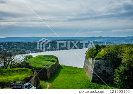 The fortress perched on Petrovaradin Hill watches over the city, while the charming streets and modern buildings of Novi Sad are spread out, creating a perfect blend of history and contemporary life 121205103