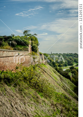 The fortress perched on Petrovaradin Hill watches over the city, while the charming streets and modern buildings of Novi Sad are spread out, creating a perfect blend of history and contemporary life 121205151