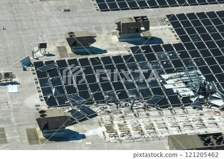 Top view of destroyed by hurricane Ian photovoltaic solar panels mounted on industrial building roof for producing green ecological electricity. Consequences of natural disaster in Florida Top view of destroyed by hurricane Ian photovoltaic solar panels mounted on industrial building roof for producing green ecological electricity. Consequences of natural disaster in Florida 121205462
