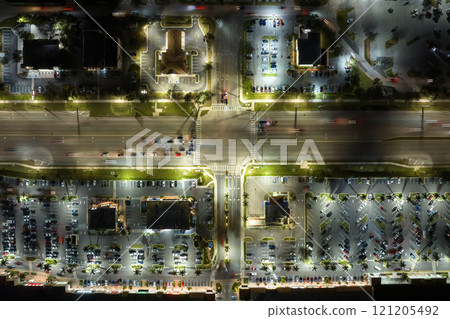 Strip mall plaza in North Port, Florida with illuminated traffic driving cars. USA transportation infrastructure concept 121205492