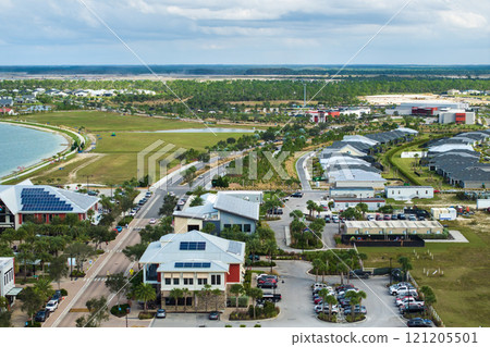 Solar rooftops in commercial center in Florida sustainable town. Photovoltaic panels for producing of clean ecological electrical energy in city area. Concept of autonomous building 121205501