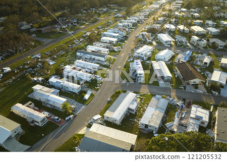 Severely damaged by hurricane Ian houses in Florida mobile home residential area. Consequences of natural disaster 121205532