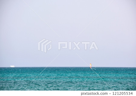 Seascape with ripple surface of blue sea water with distant ships floating on calm waves. Seascape with ripple surface of blue sea water with distant ships floating on calm waves. 121205534