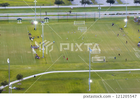 Schoolkids training in soccer game on school football stadium in sports park in North Port, Florida Schoolkids training in soccer game on school football stadium in sports park in North Port, Florida 121205547