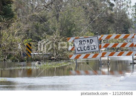 Road closed for roadworks and danger of flooding with warning signs blocking driving of cars 121205608