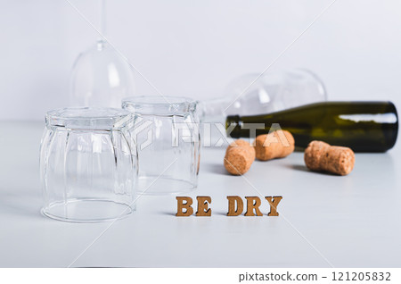 Dry January concept, empty glasses, bottles and corks on a gray background Dry January concept, empty glasses, bottles and corks on a gray background 121205832