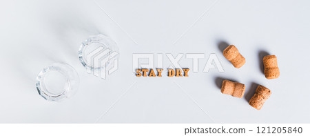 Upside down glasses, corks and text, sober january concept on grey background Upside down glasses, corks and text, sober january concept on grey background 121205840