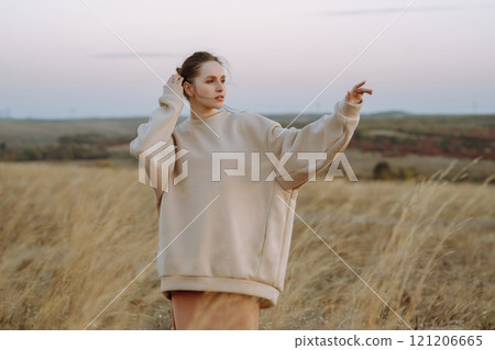 Young woman enjoys autumn day. People, lifestyle, travel, nature and vacations concept. 121206665