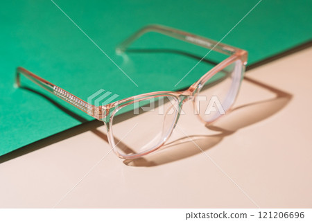 Pink eyeglasses on pastel background. Myopia Pink eyeglasses on pastel background. Myopia 121206696