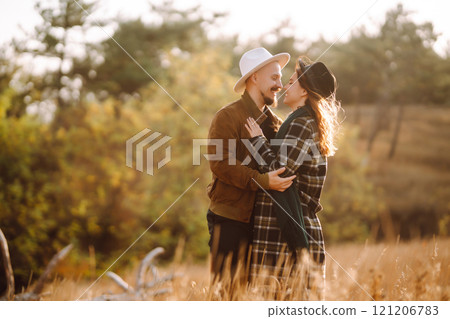 Lovely hipster couple enjoying each other in the autumn park. Nice autumn day. love and lifestyle. Lovely hipster couple enjoying each other in the autumn park. Nice autumn day. love and lifestyle. 121206783
