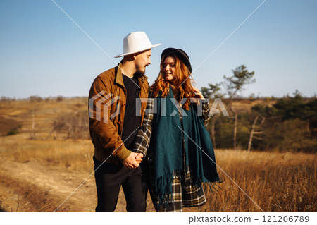 Lovely hipster couple enjoying each other in the autumn park. Nice autumn day. love and lifestyle. Lovely hipster couple enjoying each other in the autumn park. Nice autumn day. love and lifestyle. 121206789