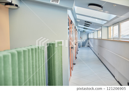 Background shot of hallway with roof windows and transparent doors leading to individual office rooms in modern business center, copy space Background shot of hallway with roof windows and transparent doors leading to individual office rooms in modern business center, copy space 121206905