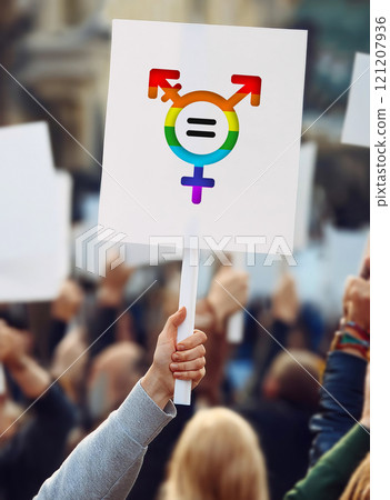 Hand holding a protest banner with transgender symbol in rainbow colors. LGBTQ+ pride rally march for sex equality 121207936