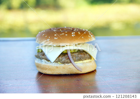 Pork meat in burger. Tasty burger ready for cooking in foil paper on fire Pork meat in burger. Tasty burger ready for cooking in foil paper on fire 121208143