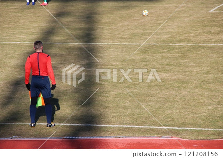 Assistant referee in football match watching the game. Linesman with flag 121208156