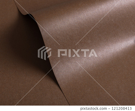Glossy mocha mousse paper background with a sleek, shimmering texture. Minimalist and modern design 121208413