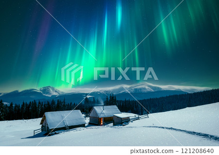 A winter scene with a solitary wooden cabins in snowy mountains 121208640
