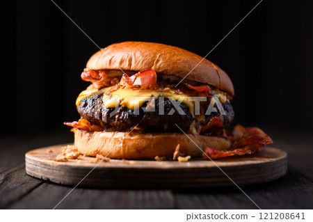 Appetizing cheeseburger on wooden board close up Appetizing cheeseburger on wooden board close up 121208641