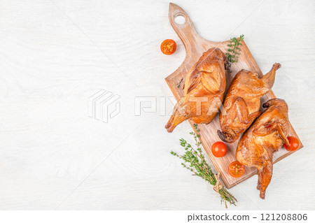 hot smoked quails with herbs and spices on wooden board, top view. copy space 121208806