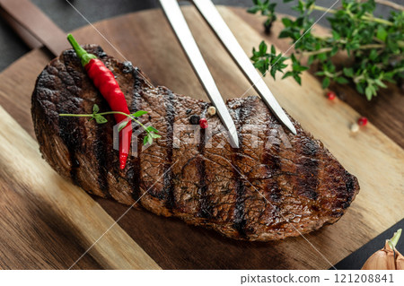 grilled steak beef meat on a wooden board, top view grilled steak beef meat on a wooden board, top view 121208841