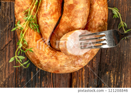 Smoked sausage on a wooden rustic board. Top view. Copy space Smoked sausage on a wooden rustic board. Top view. Copy space 121208846