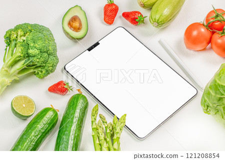 tablet with white screen for mock up with vegetarian healthy food vegetable background, shopping delivery app, cook book diet plan nutrition recipes tablet with white screen for mock up with vegetarian healthy food vegetable background, shopping delivery app, cook book diet plan nutrition recipes 121208854