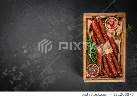 kabanosy thin dry sausages on a wooden board, top view. copy space kabanosy thin dry sausages on a wooden board, top view. copy space 121208876