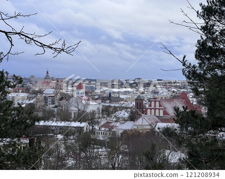 Beautiful Vilnius city panorama in winter with snow covered houses, churches and streets. Aerial evening view. Winter city scenery in Vilnius, Lithuania. 121208934
