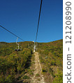 Cable car in the mountains on a background of blue sky. 121208990