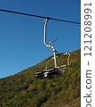 Cable car in the mountains on a background of blue sky. 121208991